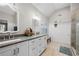 Bright bathroom featuring double sinks, modern fixtures, and wainscoting, exuding a clean and stylish aesthetic at 5661 Fairwood Nw Dr, Acworth, GA 30101