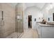 Bright bathroom featuring a glass shower and double vanity with modern finishes and neutral tile flooring at 5661 Fairwood Nw Dr, Acworth, GA 30101