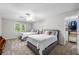 Cozy bedroom with two beds, a ceiling fan, and a window offering natural light, creating a comfortable space at 5661 Fairwood Nw Dr, Acworth, GA 30101