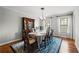 Traditional dining room with a wood table, stylish blue rug, and elegant chandelier at 5661 Fairwood Nw Dr, Acworth, GA 30101