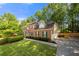 Two-story brick home with attached garage, mature trees, and a well-maintained lawn on a sunny day at 5661 Fairwood Nw Dr, Acworth, GA 30101