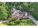 Beautiful brick home with a manicured lawn, mature trees, and long driveway at 5661 Fairwood Nw Dr, Acworth, GA 30101