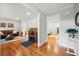 Hallway with hardwood floors, leads to living room, office space, and an open floor plan at 5661 Fairwood Nw Dr, Acworth, GA 30101