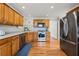 Charming kitchen featuring wooden cabinetry, stainless steel appliances, and hardwood floors at 5661 Fairwood Nw Dr, Acworth, GA 30101