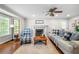 Bright living room with fireplace, large windows, and cozy seating perfect for relaxation and entertaining guests at 5661 Fairwood Nw Dr, Acworth, GA 30101