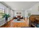 Inviting living room features hardwood floors, a leather sofa, and a bay window offering lots of natural light at 5661 Fairwood Nw Dr, Acworth, GA 30101