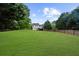 Wide view of the expansive backyard and surrounding trees at 7020 Walnut Mill Lndg, Cumming, GA 30040