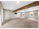 Spacious basement with carpet, natural light, and a wooden beam at 7020 Walnut Mill Lndg, Cumming, GA 30040