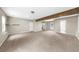 Unfinished basement with neutral walls, carpet, and structural beam perfect for future customization at 7020 Walnut Mill Lndg, Cumming, GA 30040