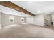 Unfinished carpeted basement with windows, doors, and stairs for future Gathering room or additional space at 7020 Walnut Mill Lndg, Cumming, GA 30040