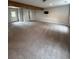 Large finished basement space with carpeting, a TV, and a door to the exterior at 7020 Walnut Mill Lndg, Cumming, GA 30040