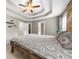 Spacious bedroom featuring a tray ceiling, ceiling fan, carpet, and wood accent wall at 7020 Walnut Mill Lndg, Cumming, GA 30040