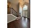 Bright foyer featuring hardwood floors, high ceilings, chandelier, staircase, and a large window above the front door at 7020 Walnut Mill Lndg, Cumming, GA 30040