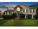 Charming home featuring stone accents, a manicured lawn, and a cozy entrance at 7020 Walnut Mill Lndg, Cumming, GA 30040