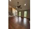 Spacious living room with hardwood floors, a ceiling fan, and a view of the front entrance at 7020 Walnut Mill Lndg, Cumming, GA 30040