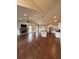 Open concept living space features a stone fireplace, kitchen island, stainless appliances, and hardwood floors at 7020 Walnut Mill Lndg, Cumming, GA 30040