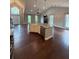 Expansive living space featuring hardwood floors, stone fireplace, kitchen island, stainless appliances, and vaulted ceiling at 7020 Walnut Mill Lndg, Cumming, GA 30040