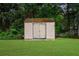 Outdoor storage shed in backyard featuring double doors and good condition at 7020 Walnut Mill Lndg, Cumming, GA 30040