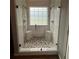 Walk-in shower with pebble flooring, tile walls, glass doors, and dual shower heads at 7020 Walnut Mill Lndg, Cumming, GA 30040
