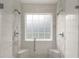 Modern shower with dual shower heads, tile surround, and a window for natural light at 7020 Walnut Mill Lndg, Cumming, GA 30040
