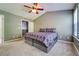 Comfortable bedroom with plush carpet, a ceiling fan, and ensuite bathroom access at 1207 Penhurst Way, Lawrenceville, GA 30043
