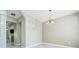 Bright dining room featuring modern light fixture and light wood-look flooring at 1207 Penhurst Way, Lawrenceville, GA 30043