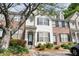 Charming townhouse with white siding, black shutters, and well-maintained landscaping at 1207 Penhurst Way, Lawrenceville, GA 30043