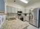 Modern kitchen featuring stainless steel appliances and granite countertops at 1207 Penhurst Way, Lawrenceville, GA 30043