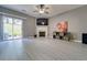 Cozy living room with a fireplace, large sliding glass doors, and recessed lighting at 1207 Penhurst Way, Lawrenceville, GA 30043