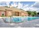 Community pool with a brick clubhouse and plenty of seating for residents to enjoy the sun at 1207 Penhurst Way, Lawrenceville, GA 30043