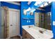 Bathroom featuring a double vanity, bright blue paint, and walk-in shower at 230 Ryan Ln, Covington, GA 30014