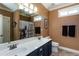 Bathroom featuring a double sink vanity with dark cabinets, a large mirror, and modern fixtures at 230 Ryan Ln, Covington, GA 30014