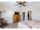 Comfortable bedroom featuring a floral bedspread, rocking chair, and modern ceiling fan at 230 Ryan Ln, Covington, GA 30014