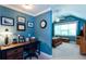 Inviting bedroom features blue walls, desk, bed and comfortable furniture at 230 Ryan Ln, Covington, GA 30014