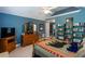 Bright bedroom featuring bookshelves, TV, dresser, bed and charming decor at 230 Ryan Ln, Covington, GA 30014