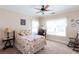 Cozy bedroom with floral bedding, rocking chair, and natural light streaming through the windows at 230 Ryan Ln, Covington, GA 30014