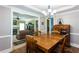 Inviting dining room with wood table and chairs, open to living room with fireplace and stairs at 230 Ryan Ln, Covington, GA 30014