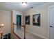 Upstairs hallway with neutral walls and framed artwork, creating an inviting space at 230 Ryan Ln, Covington, GA 30014