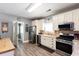 Bright kitchen features white cabinets, stainless steel appliances, and light grey walls at 230 Ryan Ln, Covington, GA 30014
