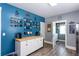 A beautifully decorated kitchen showcasing blue accent wall with coffee cup decor and white cabinetry at 230 Ryan Ln, Covington, GA 30014
