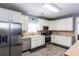 Well-lit kitchen featuring white cabinets, stainless steel appliances, and a modern design at 230 Ryan Ln, Covington, GA 30014