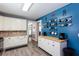 Bright kitchen with an accent wall, mug rack, white cabinets, stainless appliances and a butcher block countertop at 230 Ryan Ln, Covington, GA 30014