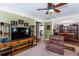 Open-concept living room showcasing a TV, storage shelves, and view into the dining area at 230 Ryan Ln, Covington, GA 30014