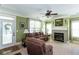 Comfortable living room with a fireplace, large windows, and access to the backyard at 230 Ryan Ln, Covington, GA 30014