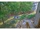 Large backyard with a stone fire pit surrounded by chairs and ample space for outdoor activities at 4410 Red Rock Pt, Suwanee, GA 30024