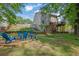 Inviting backyard with a fire pit and Adirondack chairs, ideal for outdoor entertaining at 4410 Red Rock Pt, Suwanee, GA 30024