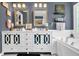 Modern bathroom featuring double vanity, granite countertops, bathtub, and tile floors at 4410 Red Rock Pt, Suwanee, GA 30024