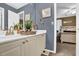 Bathroom featuring modern vanity with granite counters, neutral walls, and natural light from a window at 4410 Red Rock Pt, Suwanee, GA 30024