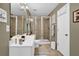Bathroom with double sink vanity, framed mirror, tiled walk-in shower, and stylish decor at 4410 Red Rock Pt, Suwanee, GA 30024