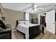 Bedroom with a ceiling fan, neutral paint, bedside table, and soft carpet at 4410 Red Rock Pt, Suwanee, GA 30024